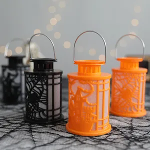 Decorative Halloween lanterns with spider and castle cutouts, orange and black colors.