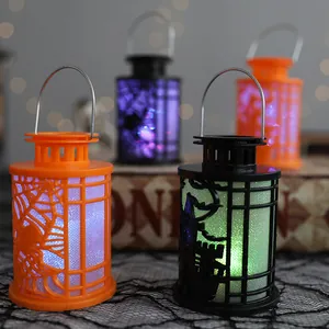 Set of 4 glowing Halloween lanterns featuring spider web and haunted house designs for decor
