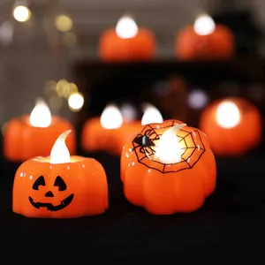 Decorative Halloween LED pumpkin candles with warm glowing light for festive party ambiance