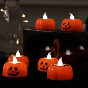 Glowing Halloween pumpkin LED tea light candles for festive holiday party decor