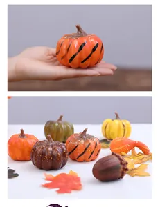 Detailed view of assorted artificial pumpkins, maple leaves and acorns for Halloween decor