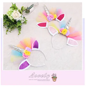 Close-up view of three colorful unicorn headbands with glitter ears and flowers
