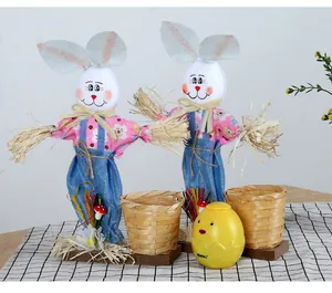 Detail view of handmade Easter bunny scarecrow decorations featuring small bamboo baskets