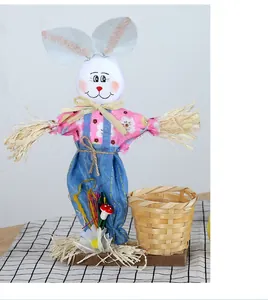 Handmade Easter bunny scarecrow decoration with a woven bamboo basket on wooden base