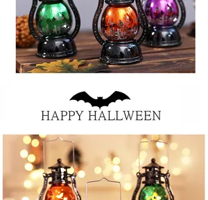 Vintage colorful Halloween electronic lanterns with bat silhouettes on wooden table