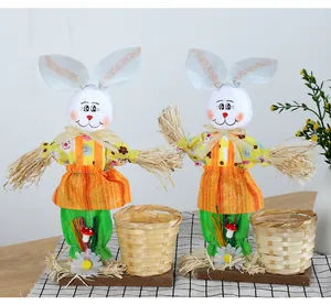 Pair of handcrafted Easter bunny straw scarecrows with small bamboo gift baskets