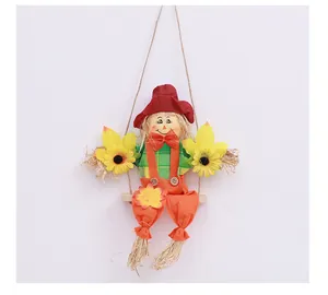 Detailed view of a decorative Halloween scarecrow doll sitting on a wooden swing hanging ornament