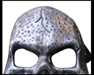 Close-up of Halloween skull mask with textured metallic finish and hollow eye sockets.