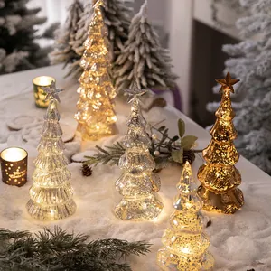 Elegant glass Christmas tree table decoration with warm LED lights for holiday atmosphere