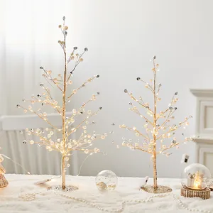 Elegante decoratieve kersttafelbomen met warme LED-verlichting en parelaccenten