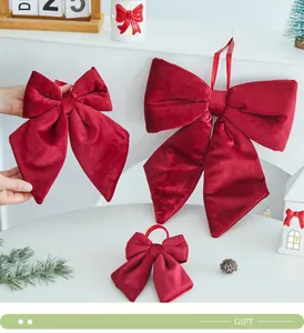 Set of three deep red velvet Christmas bow ornaments in various sizes for holiday decor.