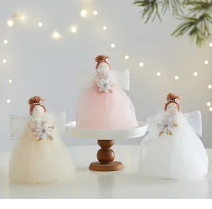 Close-up of three cute Christmas angel dolls with tulle skirts and sparkling wings