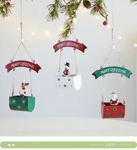 Detailed view of three metal hot air balloon Christmas ornaments with hanging banners.