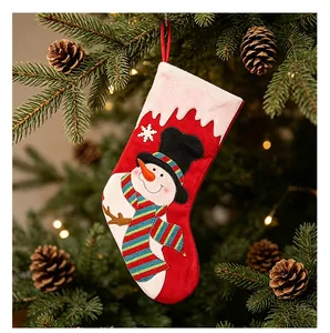 Festlicher roter Weihnachtsstrumpf mit süßem Schneemann an einem verzierten Tannenbaum