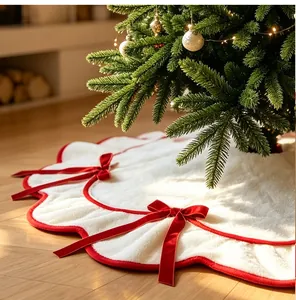 Detailed texture of white plush Christmas tree skirt with red wavy trim and velvet bows