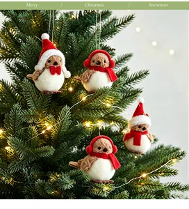 Set of adorable felt Christmas bird ornaments with Santa hats and scarves on a tree.