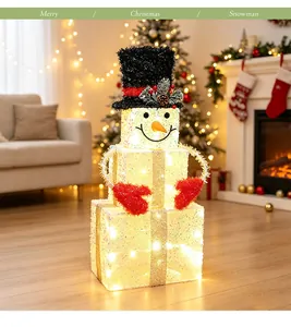 Lighted three-tiered snowman gift box decoration in a cozy home Christmas setting