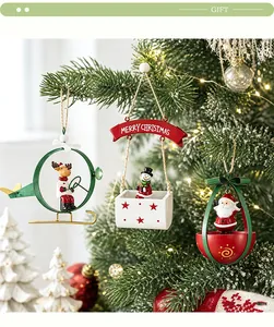 Close-up of festive Christmas iron ornaments featuring Santa and Reindeer hanging on a tree