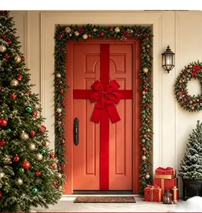Beautiful large red velvet bow with matching ribbon installed on a front door for Christmas