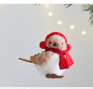 Detailed view of a cute plush Christmas bird ornament with red scarf and earmuffs hanging