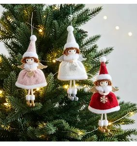 Set of three handcrafted knitted Christmas angel girl doll ornaments hanging on a tree