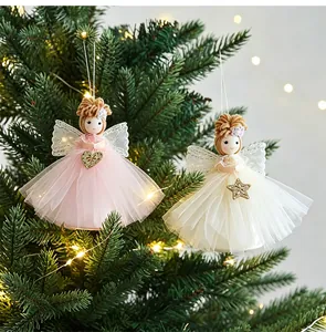 Close-up of pink and cream mesh skirt angel girl ornaments hanging on a Christmas tree