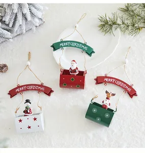 Detail of three iron Christmas hanging ornaments featuring Santa, snowman, and reindeer.