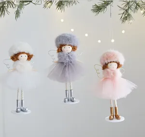 Set of three cute Christmas angel doll ornaments with mesh skirts hanging from pine branch