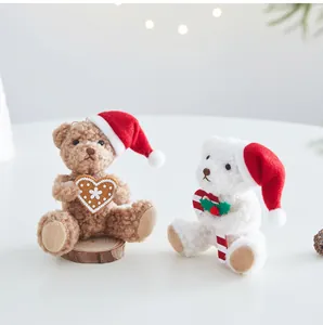 Detail of cute plush Christmas bears with heart cookie and candy cane decoration