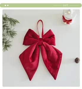 Detail view of a soft red velvet Christmas bow ornament for tree decoration