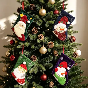 Small festive Christmas stockings with Santa and Snowman designs for tree decoration