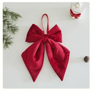Detailed view of plush red velvet bow ornament with elegant long tails for Christmas tree
