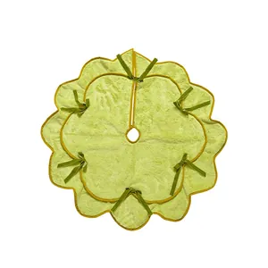 Soft plush wavy light green Christmas tree skirt featuring decorative dark green bow ribbons