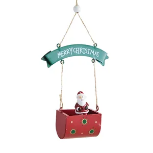 Hanging metal Christmas ornament with Santa Claus in a red basket, festive decor