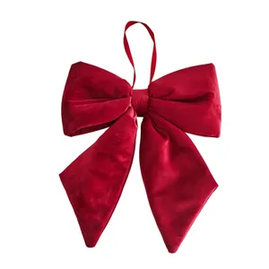 Large red velvet Christmas bow ornament with hanging loop for festive tree decoration