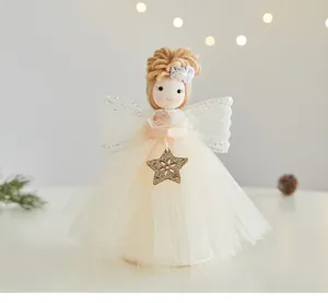 Detailed shot of a cute white Christmas angel doll ornament with a gold glittery star