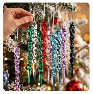 Close-up of colorful twisted acrylic icicle ornaments hanging on a snowy Christmas tree