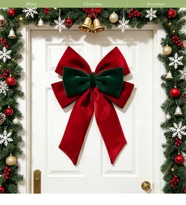 Detailed view of a large red and green velvet Christmas bow decoration on a white door.