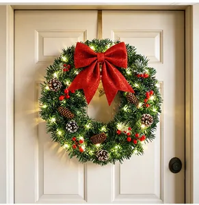 Couronne de Noël festive avec lumières LED chaudes et un grand nœud rouge scintillant