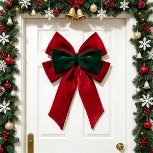 Large red and green velvet Christmas bow decoration hanging on a white door in festive scene
