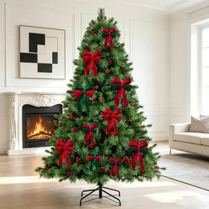 Elegant red and green velvet Christmas bows decorating a lush evergreen tree in a cozy room