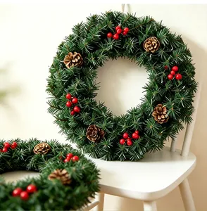 Close-up view of a lush green Christmas wreath decorated with pine cones and red berries