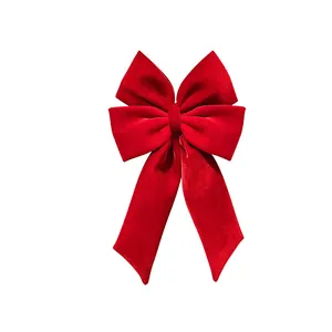 Large red velvet Christmas bow for Christmas tree decoration and festive scene layout.