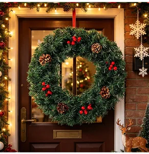 Traditional artificial Christmas wreath with pine cones and red berries on a wooden front door