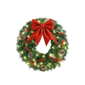 Couronne de Noël artificielle lumineuse avec grand nœud rouge et pommes de pin pour porte