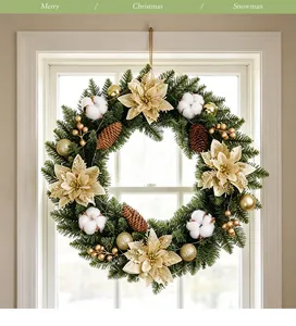 Detailansicht eines üppigen Weihnachtskranzes mit goldenen Poinsettien und Baumwollbällen