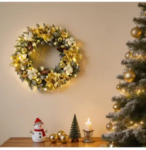Close-up of a glowing Christmas wreath with gold flowers and pine cones on a wall