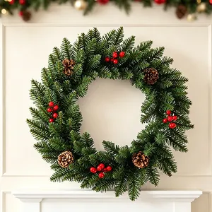 Traditioneller Weihnachtskranz mit grünen Tannennadeln, Kiefernzapfen und roten Beeren für Tür