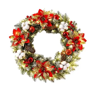 Lush pre-lit Christmas wreath with red poinsettias, cotton bolls and pine cones
