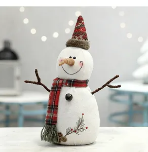 Gedetailleerd zicht op een charmante stoffen sneeuwpop met een rood geruite sjaal en muts.